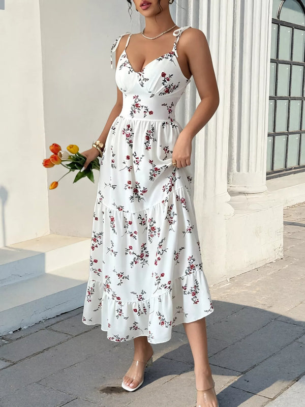 White rose-print midi dress with tiered skirt and V-neck bodice, styled with tulips