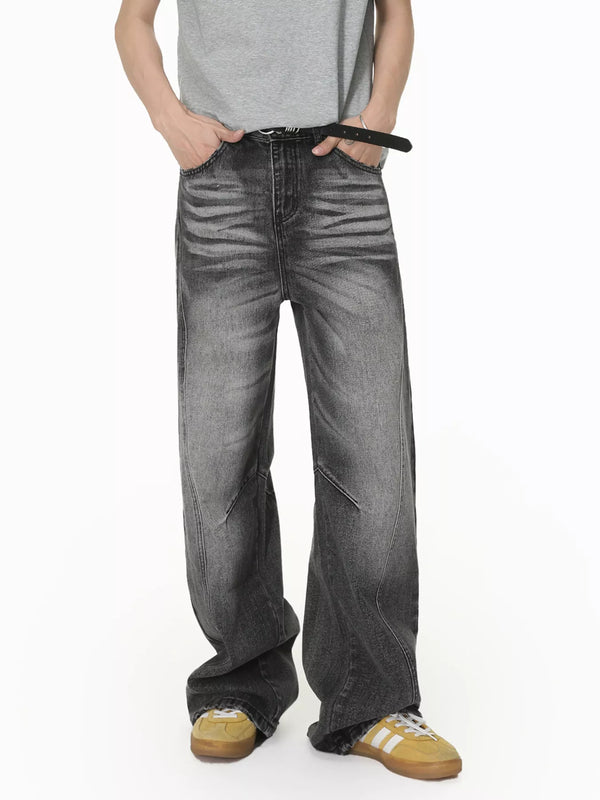 Front view of men's grey vintage-wash wide-leg jeans with faded thighs