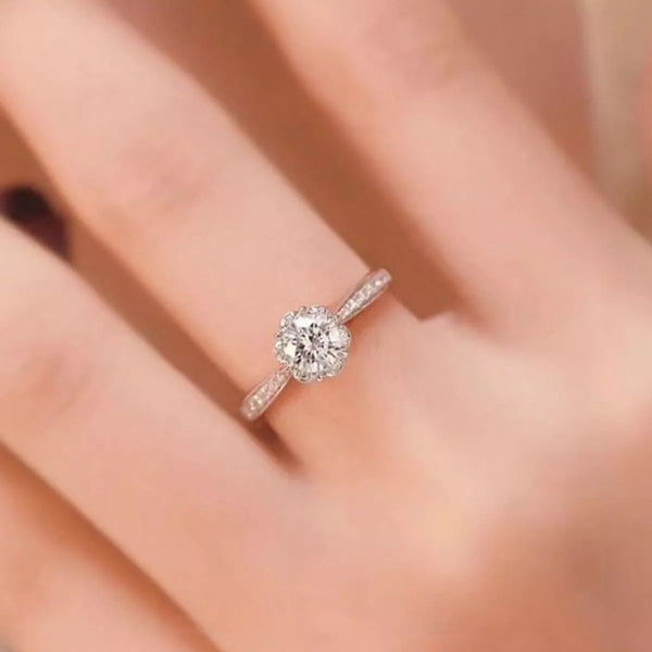 Close-up of round moissanite solitaire ring on a finger