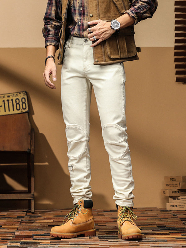 Front view of men's off-white slim-fit jeans with shaped knee panels and lower-leg zips