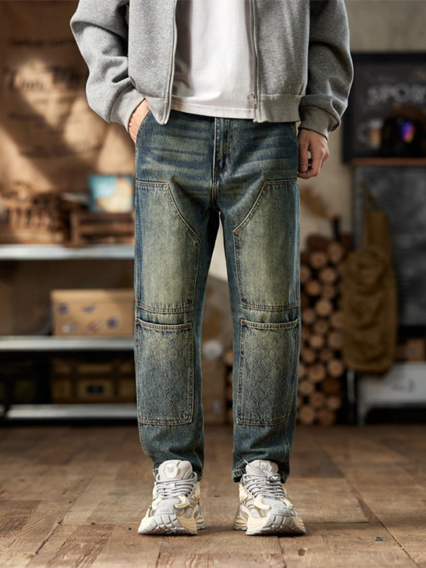Front view of men's blue vintage-wash straight-leg jeans with stitched thigh and knee panels