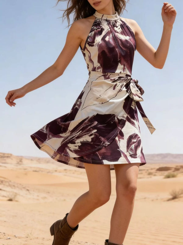 Modeled view of the burgundy and cream halter mini dress with a tied wrap-style skirt.