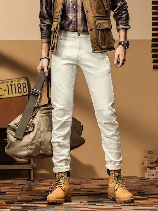 Off-white slim-fit jeans styled with a checked shirt, brown vest and tan boots