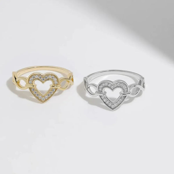 Gold-tone and silver-tone crystal heart rings displayed side by side