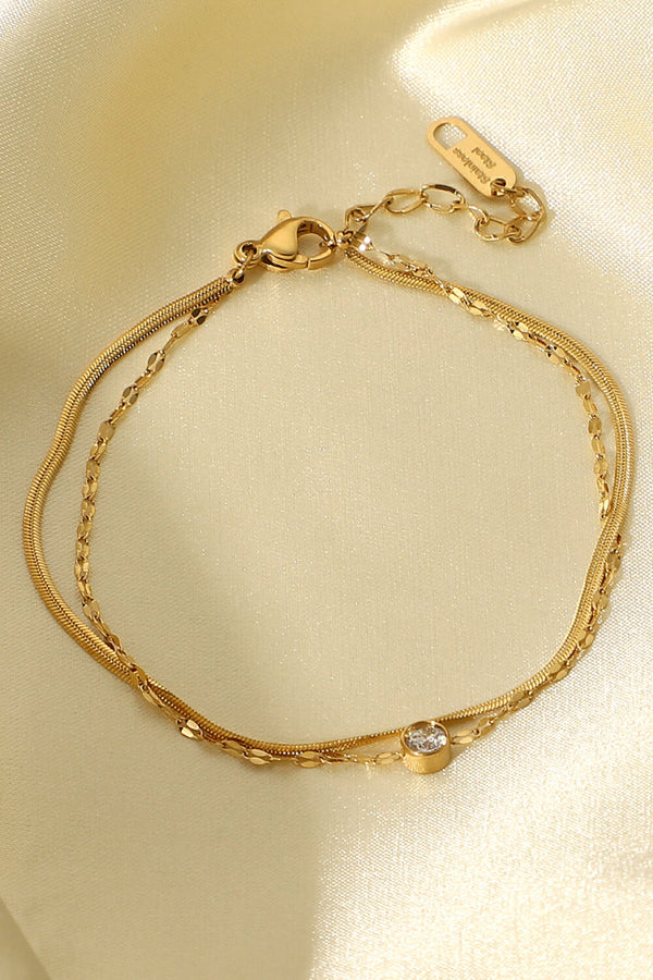 Close-up of the layered gold chains and rhinestone setting