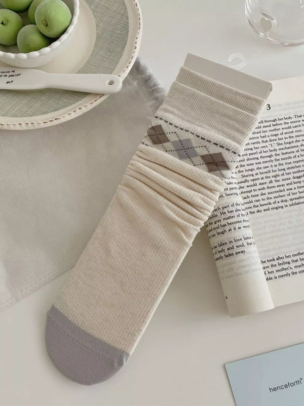 Cream mid-calf sock with gray argyle band and gray toe