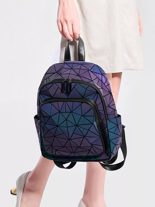 Geometric iridescent backpack held by its top handle