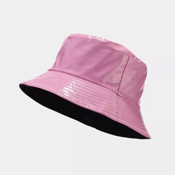 Glossy pink bucket hat with black underside, shown at an angle
