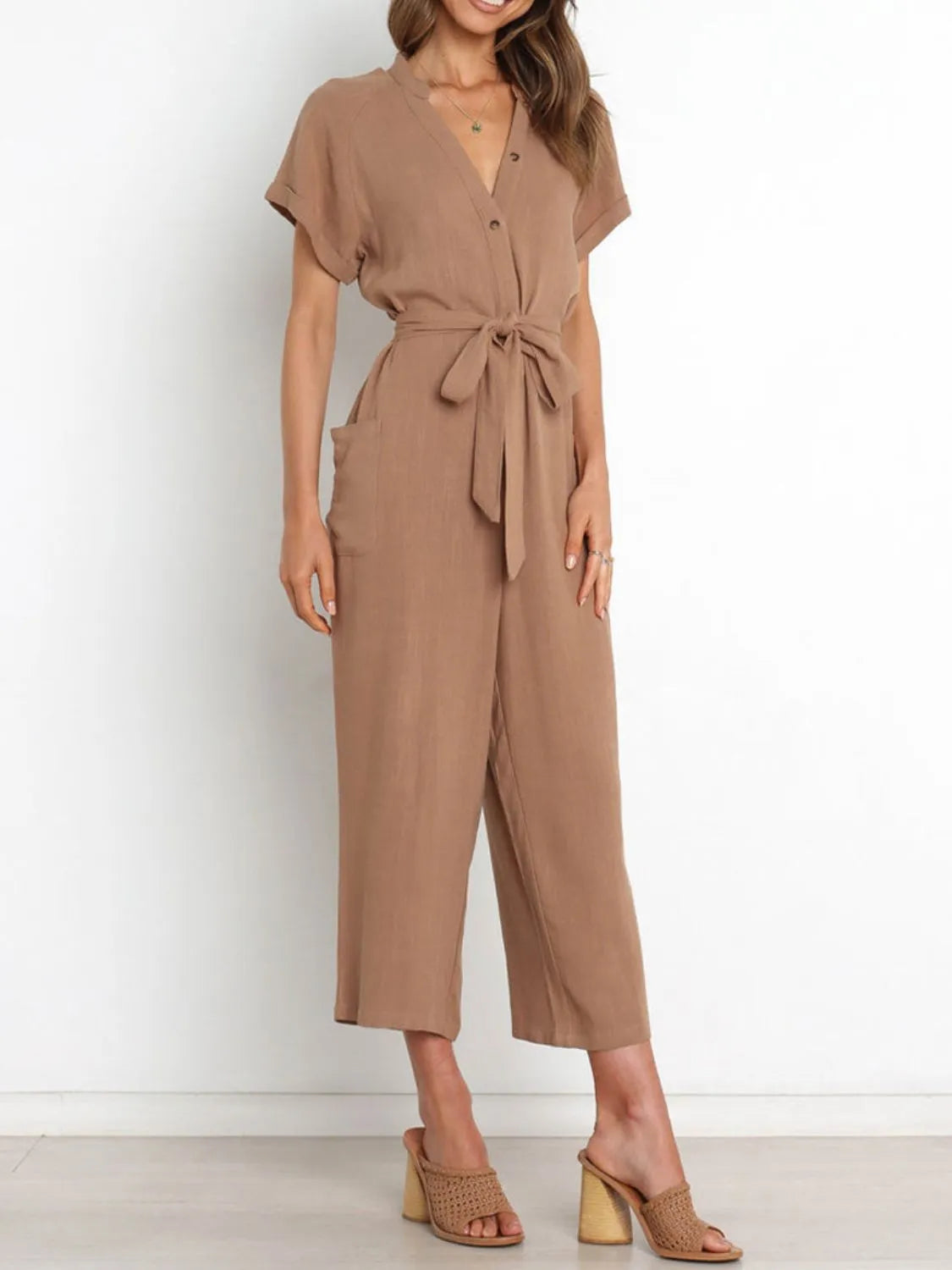 Women's camel notched-neck jumpsuit, front view with hands at sides