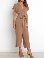 Women's camel notched-neck jumpsuit, front view with hands at sides