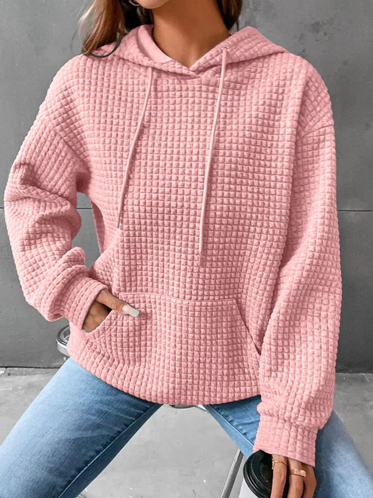 Pink textured hoodie with drawstring hood and front pocket