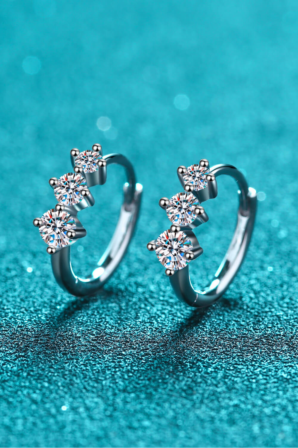 Angled pair view of moissanite huggie hoop earrings