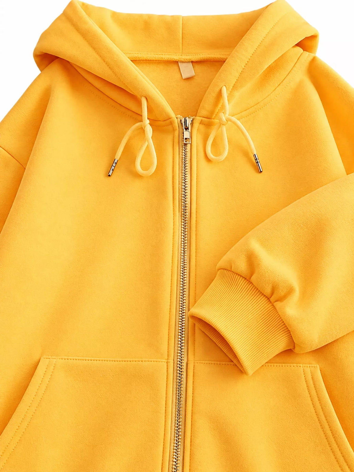 Close-up of the yellow hoodie hood, drawstrings, zipper and pocket details