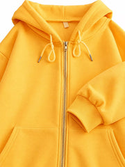 Close-up of the yellow hoodie hood, drawstrings, zipper and pocket details