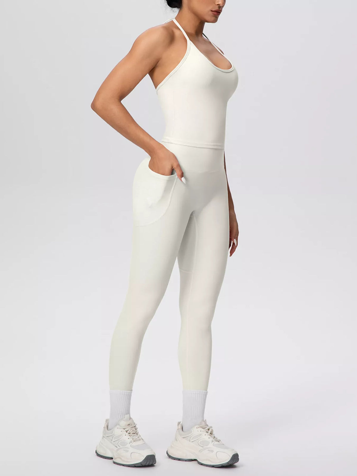 Full-length front view of halter neck cami and high-waisted leggings active set