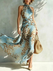 Sky-blue leopard-print sleeveless halter maxi dress with waist cutout and flowing skirt