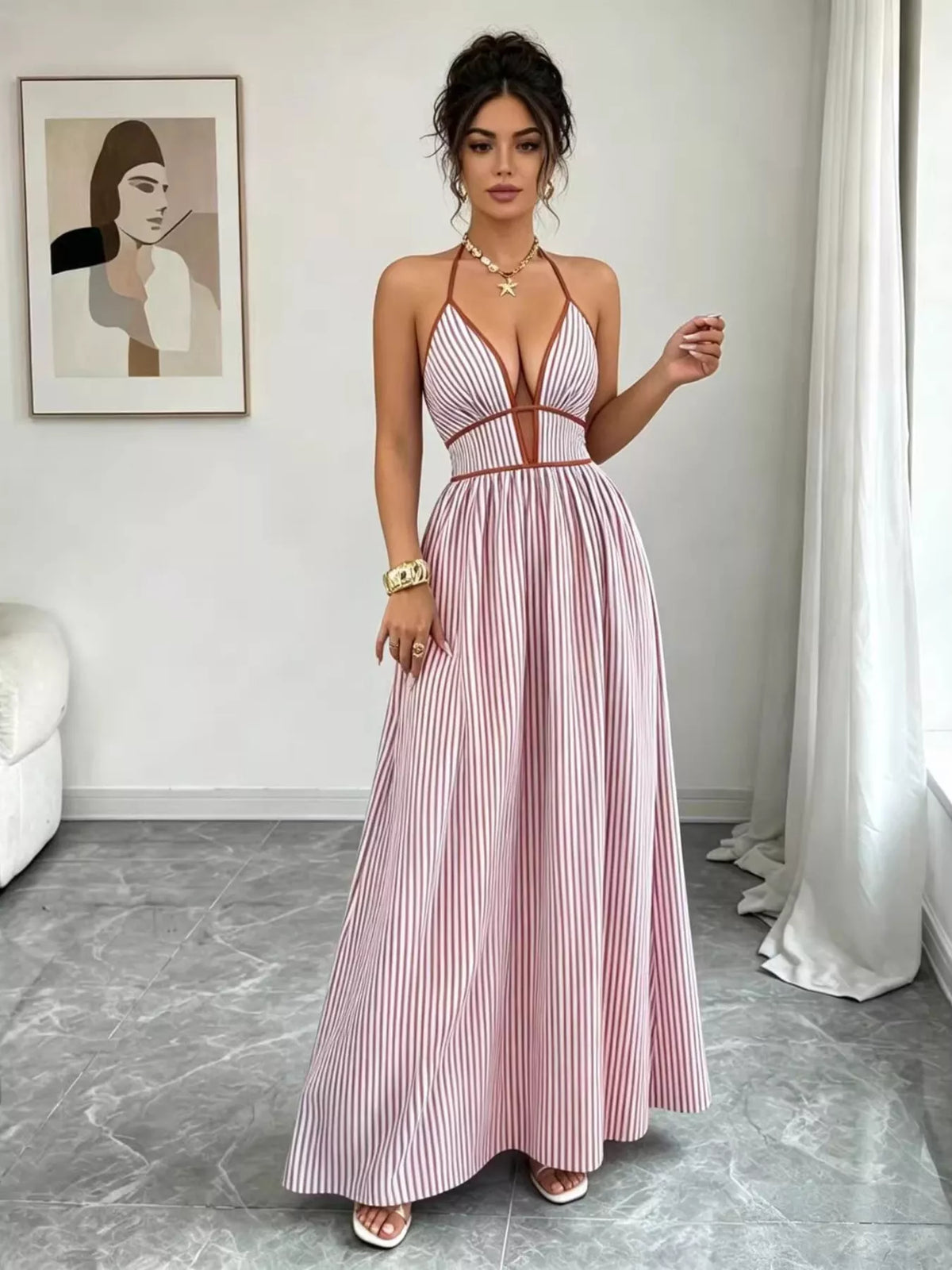 Pink halter maxi dress shown from the front with gathered waist