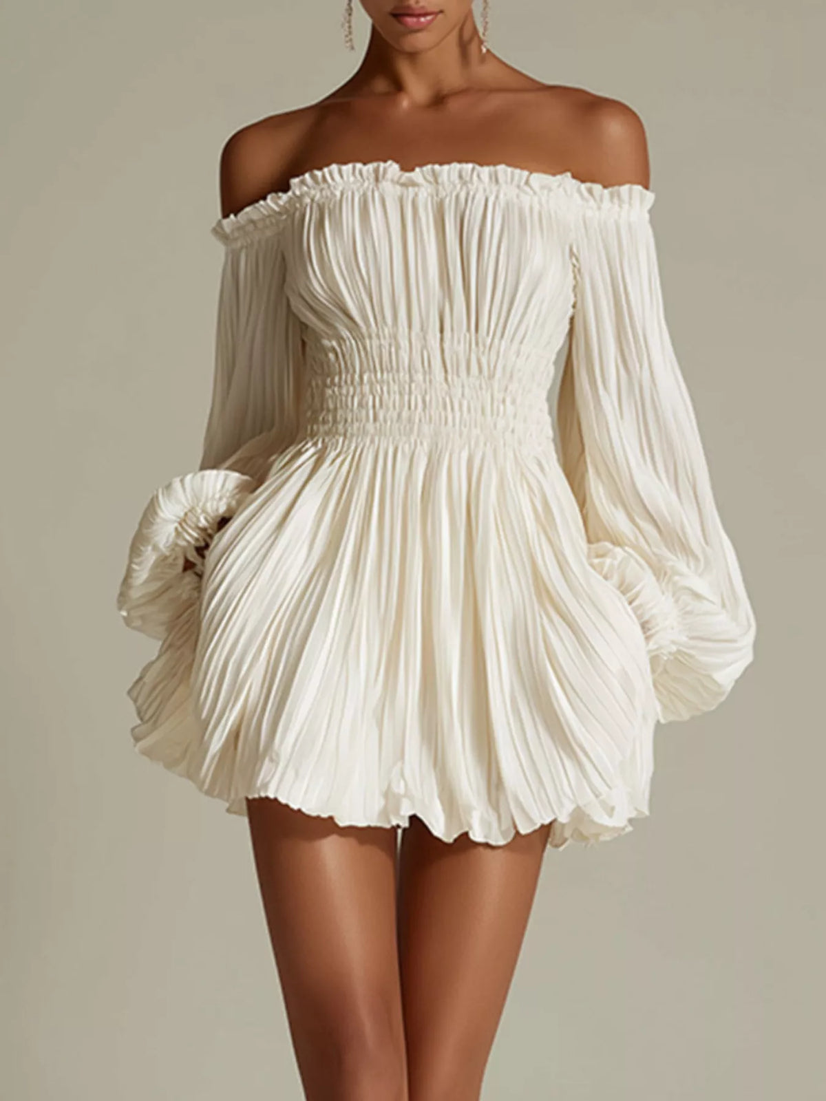 Front view of white off-shoulder mini dress with long sleeves, pleated fabric, and a smocked waist