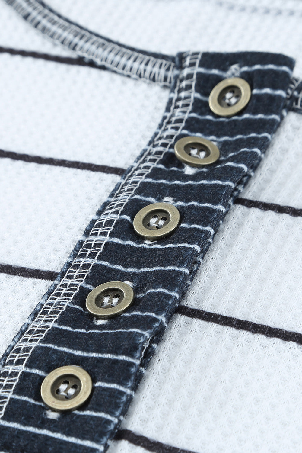 Close-up of Henley placket with dark buttons
