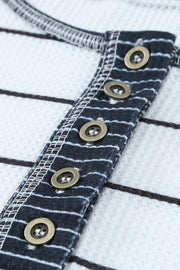 Close-up of Henley placket with dark buttons