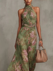Front view of the green floral sleeveless maxi dress with a long tiered skirt.