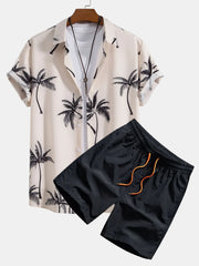 Cream short-sleeve button-front shirt with black palm tree print and dark shorts