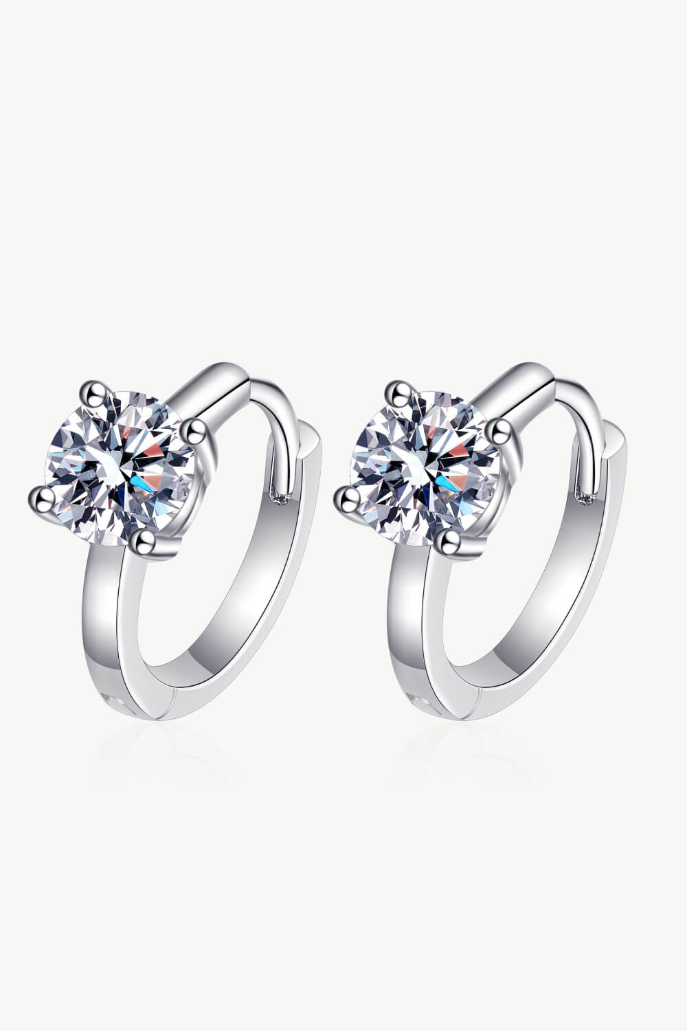 Pair of silver huggie earrings with round stones, front view