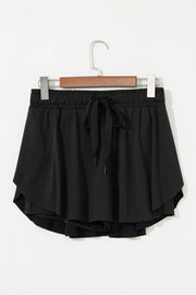 Black active skort shown from the back, with a wide elastic waistband and layered flounce