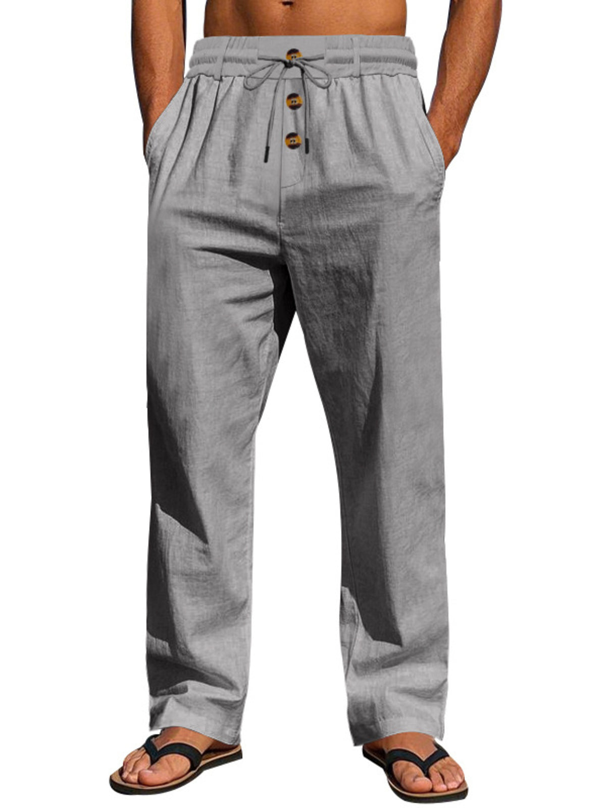 Gray drawstring pants with button-front detail, modeled with hands in pockets