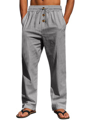 Gray drawstring pants with button-front detail, modeled with hands in pockets