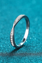 Front view of a slim pavé half-eternity ring standing on teal.