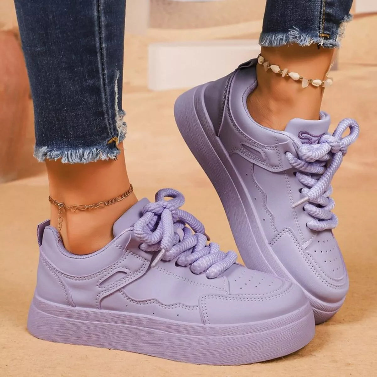 Lavender platform sneakers worn with jeans