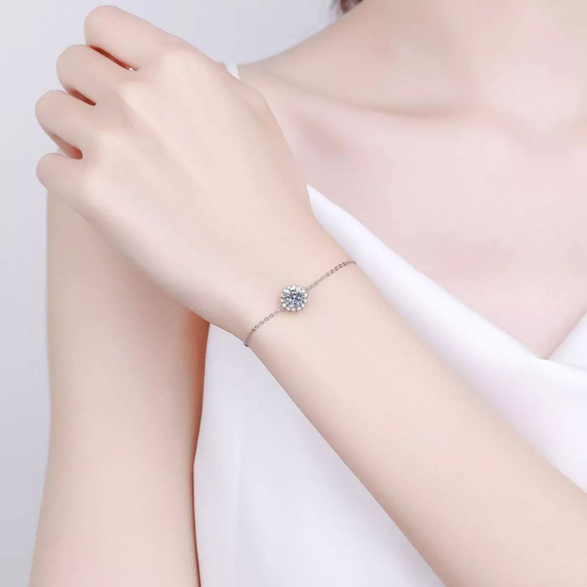 Silver moissanite bracelet worn on wrist against a pale background