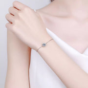 Silver moissanite bracelet worn on wrist against a pale background