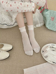 Light-colored crew socks shown on feet