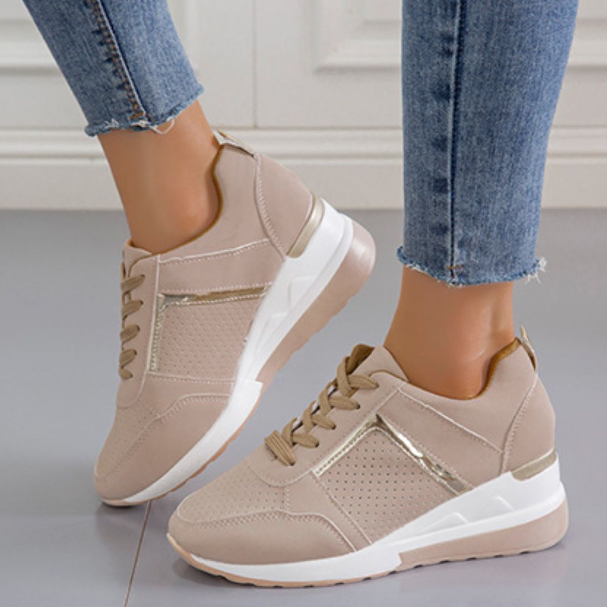Beige wedge sneaker showing raised heel and side panel