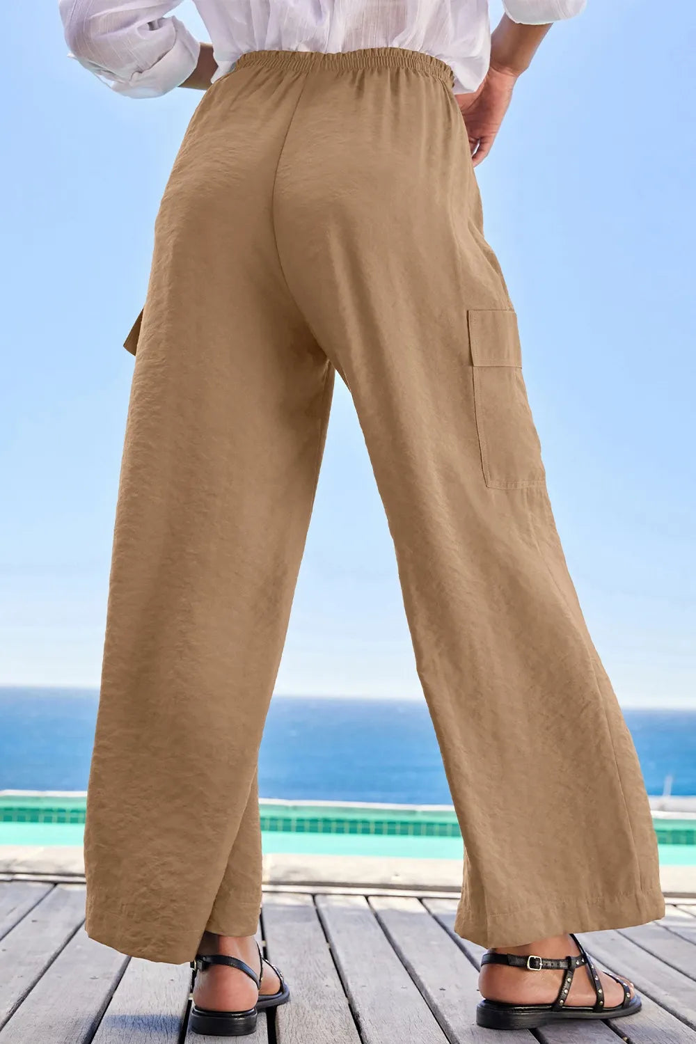 Back view of tan wide-leg utility trousers