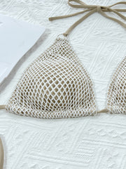 Close-up of cream fishnet triangle cups with small rings at the halter straps