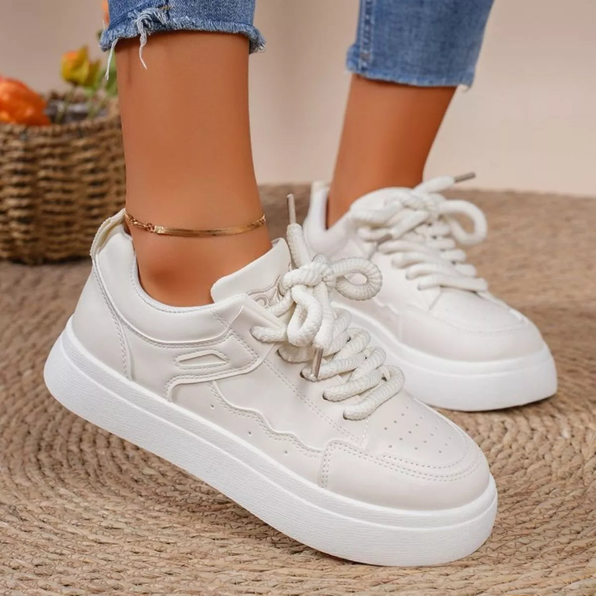White platform sneakers worn with jeans, side view