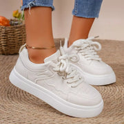 White platform sneakers worn with jeans, side view
