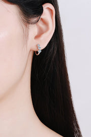Moissanite huggie earring worn on ear