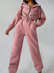 Women's rose pink hooded jumpsuit, model angled front pose with hand at waist