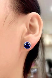 Contrast 2 Carat Moissanite Platinum-Plated Stud Earrings — Blue moissanite studs worn on an ear