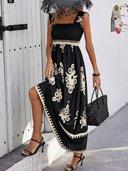 Model wearing black printed maxi dress with flowing skirt