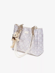 Angled view of geometric jacquard tote and chain handle attachments