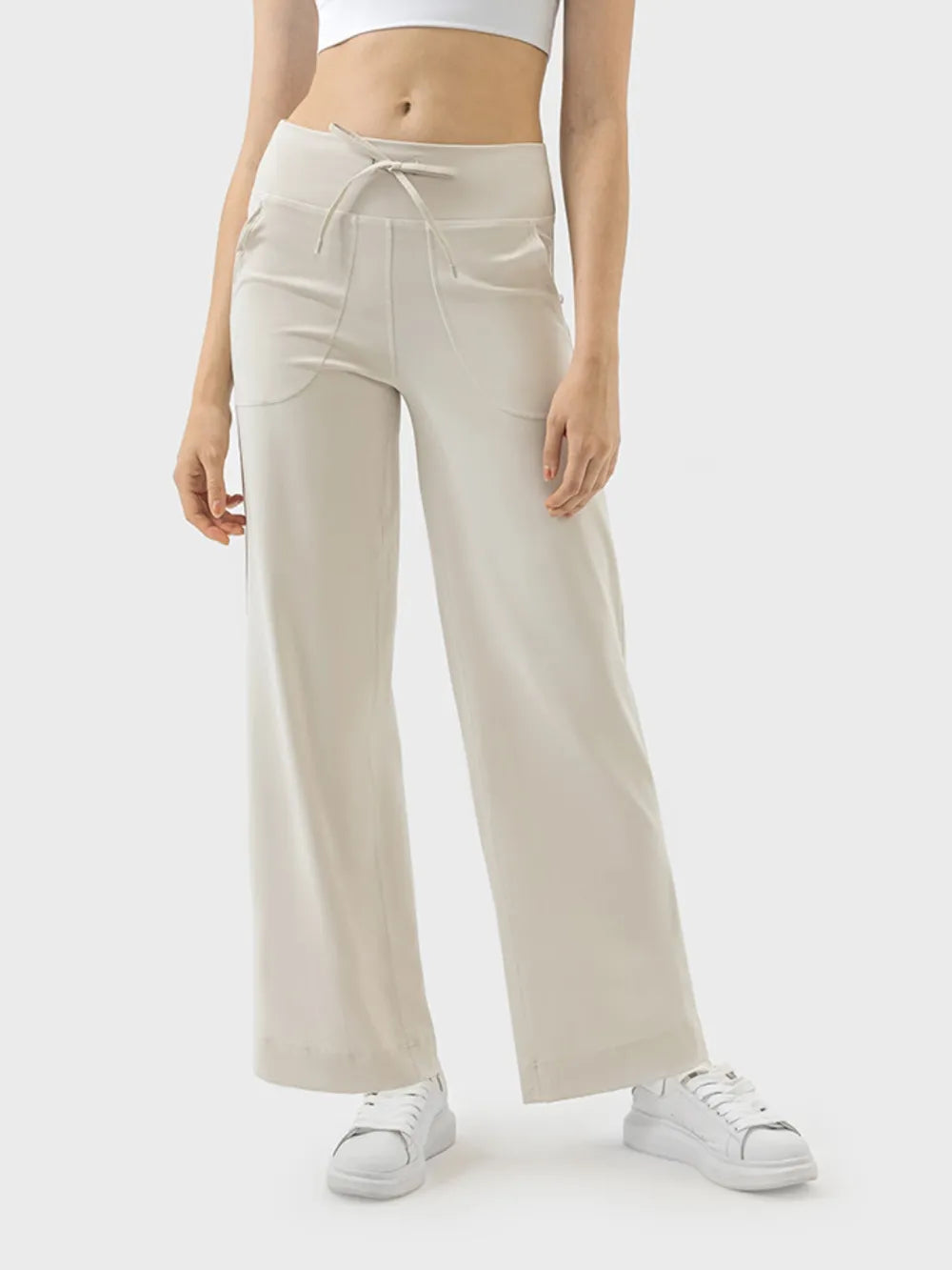 Blue pants with drawstring waist and pockets, front view