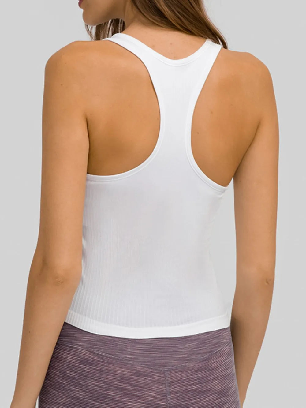Back view of white racerback tank on model