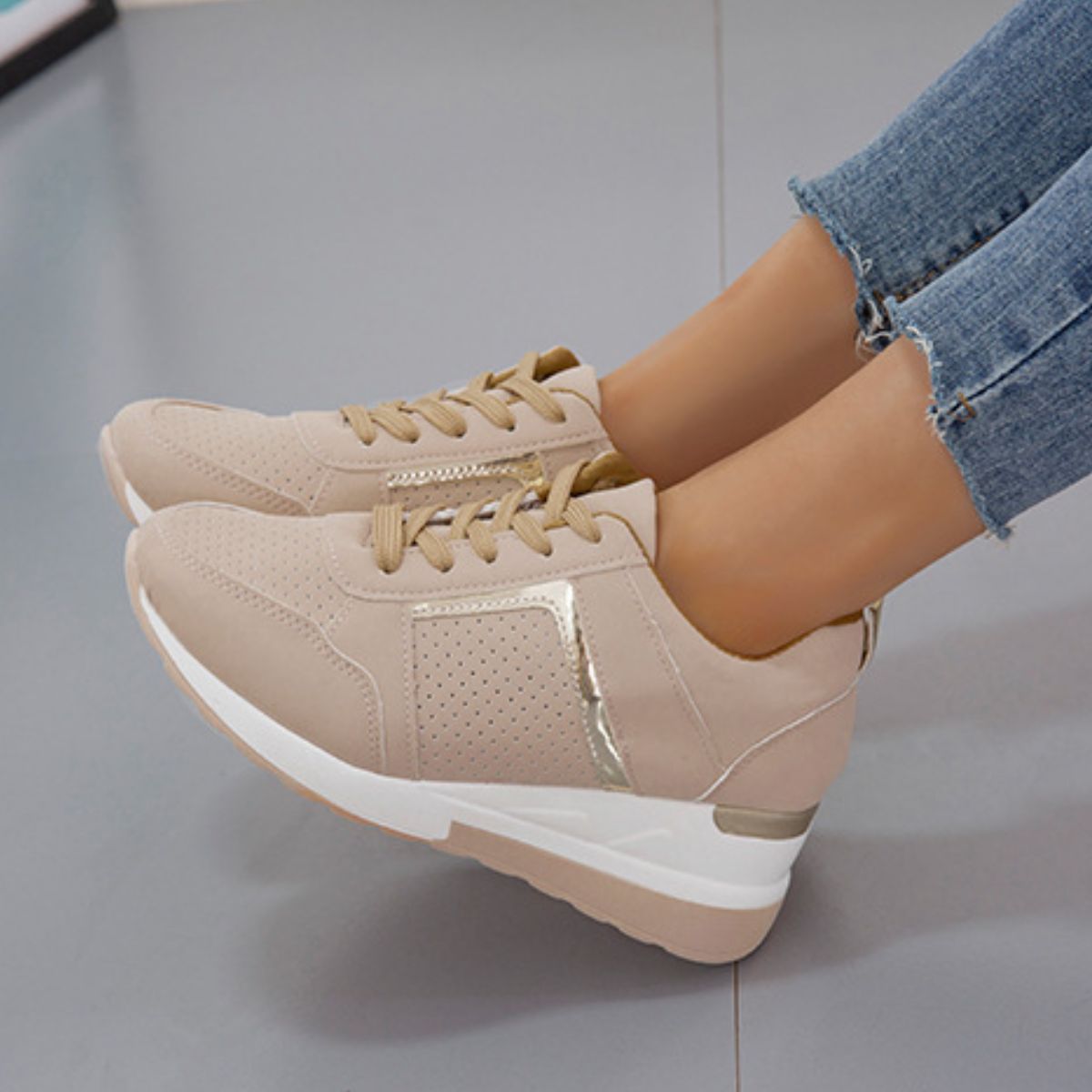 Close side view of beige wedge sneaker and laces