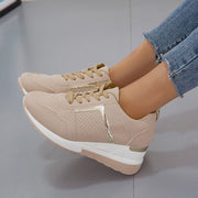 Close side view of beige wedge sneaker and laces