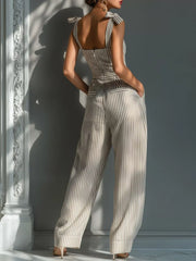 Back view of the striped jumpsuit showing its open back, tied straps and wide legs.